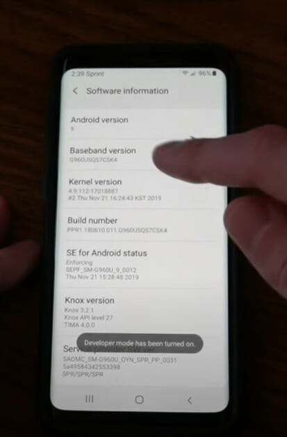 A person tapping on the 'Baseband version' option of a phone's Software Information setting