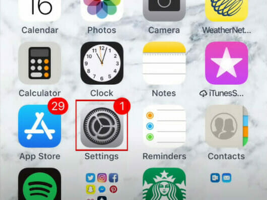 A screenshot of an iPhone's homescreen with app icons in it, and a red box on the Setting wrench icon