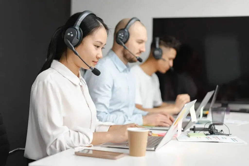A group of people working with headphones in a conference table