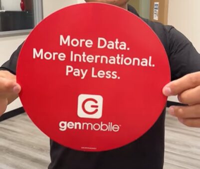 A person holding a round cardboard of a genmobile