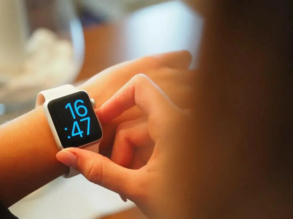 A woman checking her apple watch on her wrist