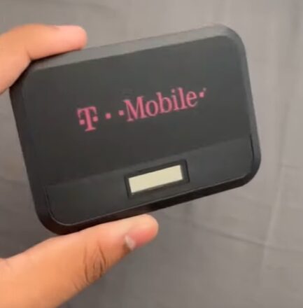 A person holding a T Mobile device
