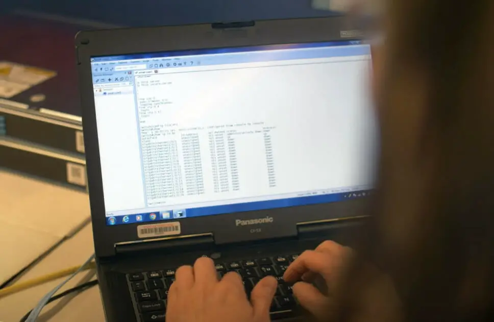 A person typing on a laptop computer