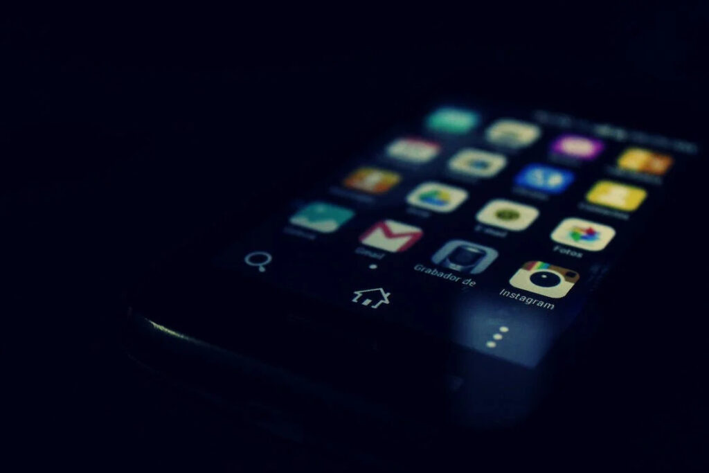 A phone in a black background showing the icons of the installed apps in it