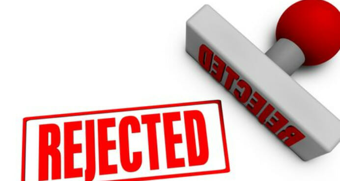A plastic paper stamp in gray and red with the word REJECTED in it