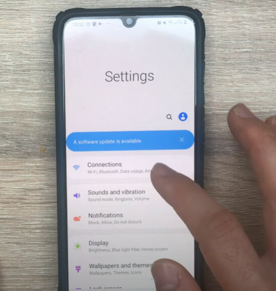 A person tapping on the Connections phone setting