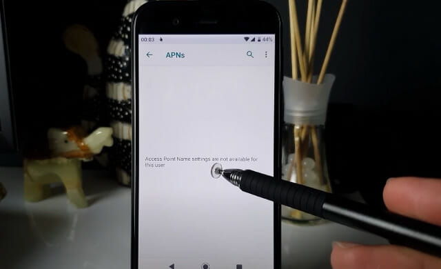 A person is using a digital pen to edit the phone's APN setting