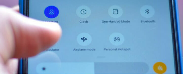 A person holding a phone with the options on the toggle settings