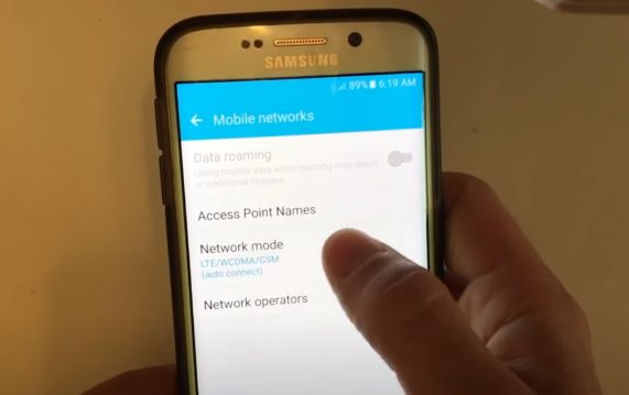 A person showing the Mobile networks settings on the phone
