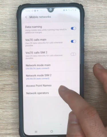 A person tapping the Access Point Names option on the Mobile networks settings