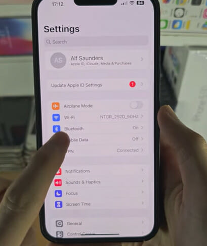 A person showing the phone's settings option list