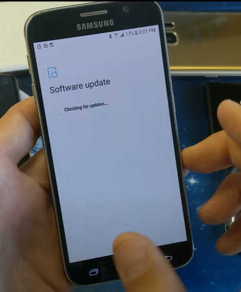A person holding a phone and showing the Software Update message