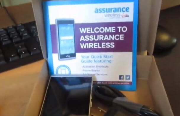 A box with a cell phone and a welcome to assurance wireless sign