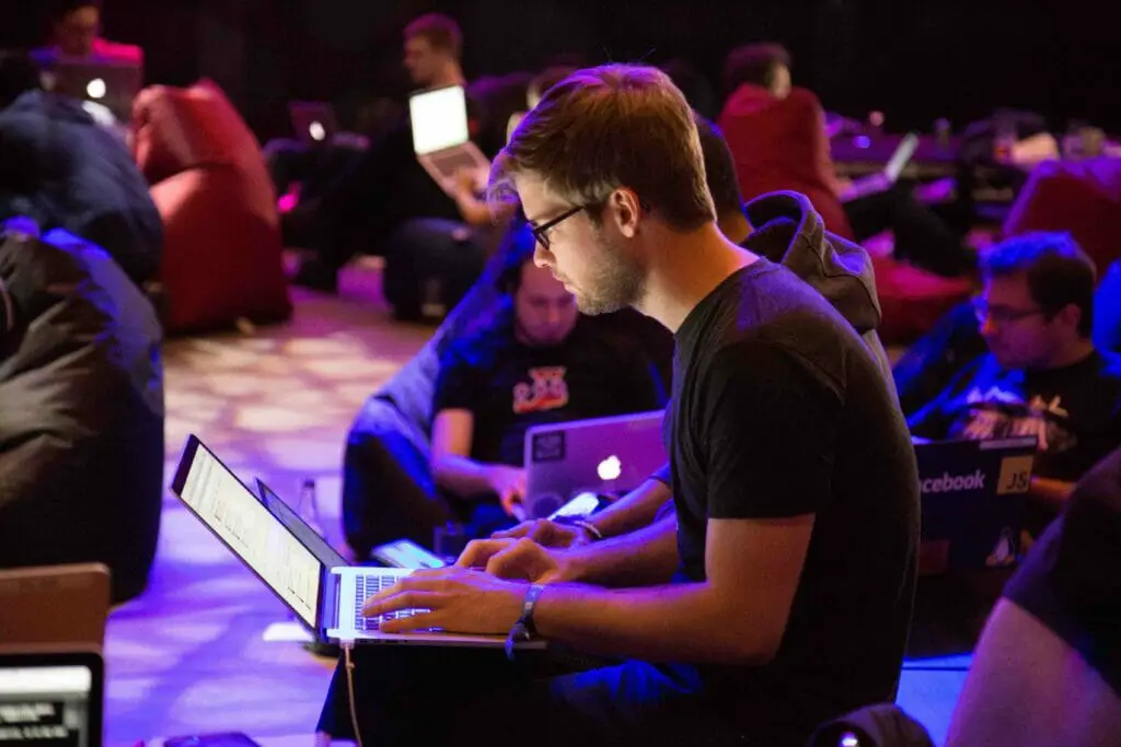 A group of people in a room using their laptops