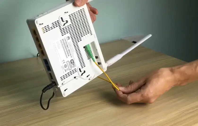 A person holding a router and its wire