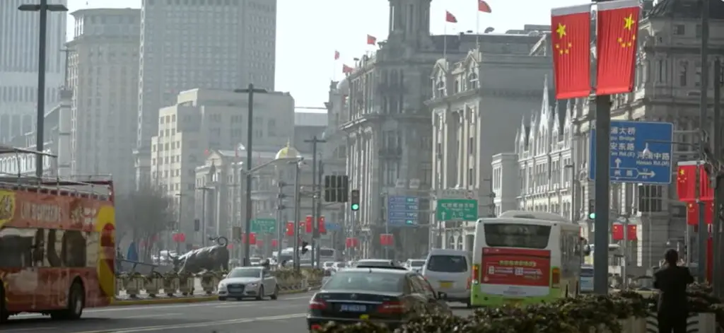 A city with a Chinese flag on the post