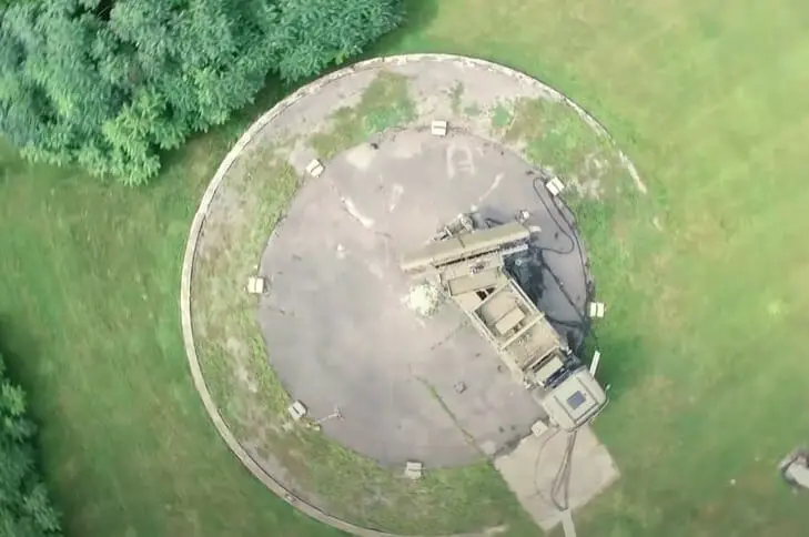 An aerial view of a circular structure in the middle of a field