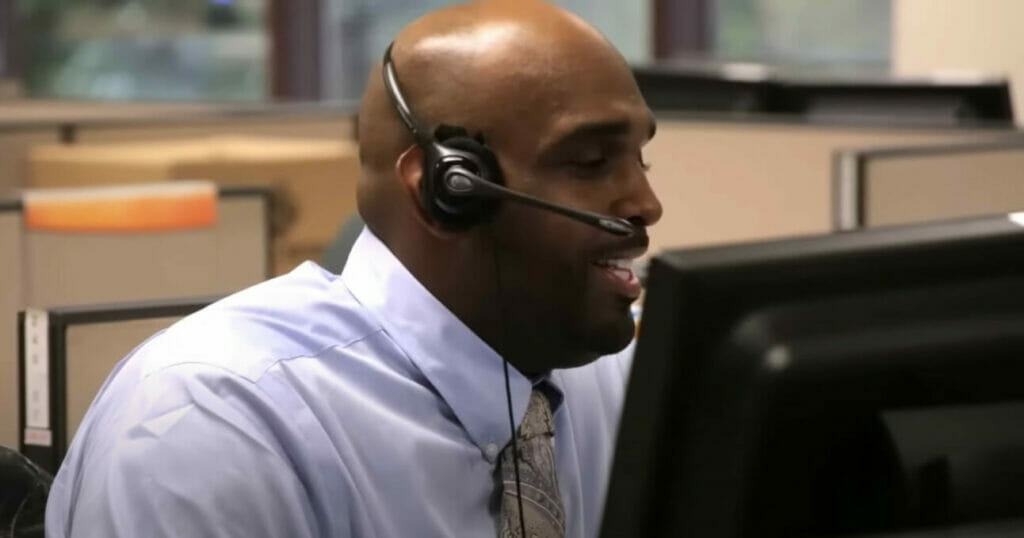 A man wearing a headset in a call center