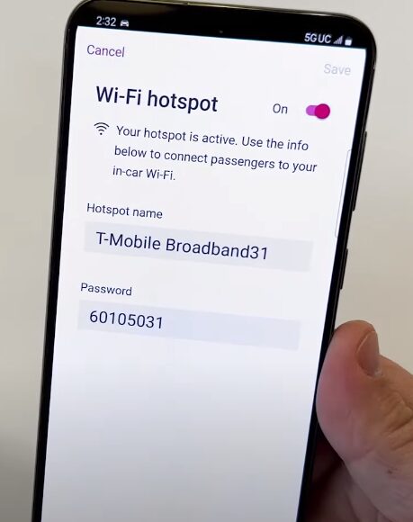 A person holding up a phone with a wifi hotspot enabled