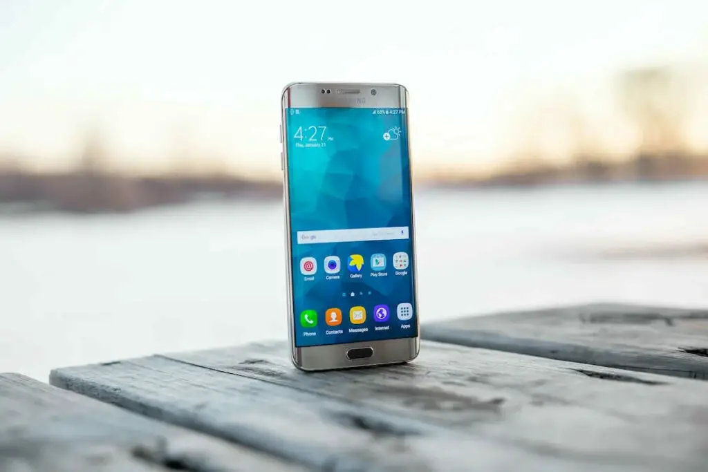 The samsung galaxy s6 is sitting on a wooden table