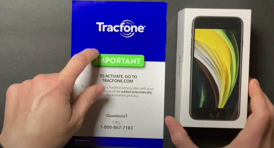 A person unboxing a Tracfone