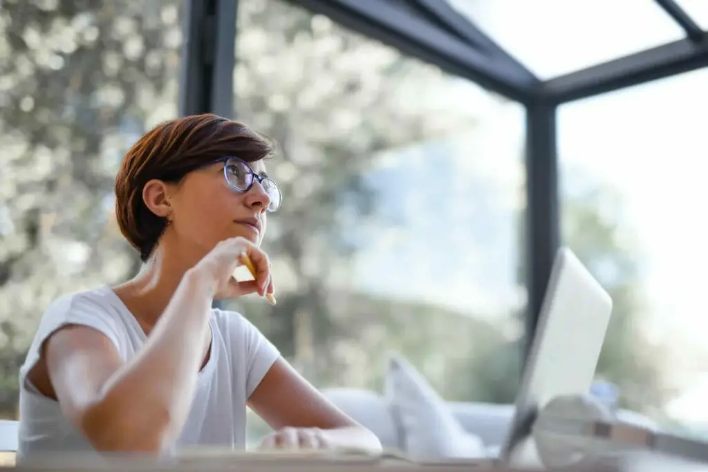 A woman sitting while using her laptop