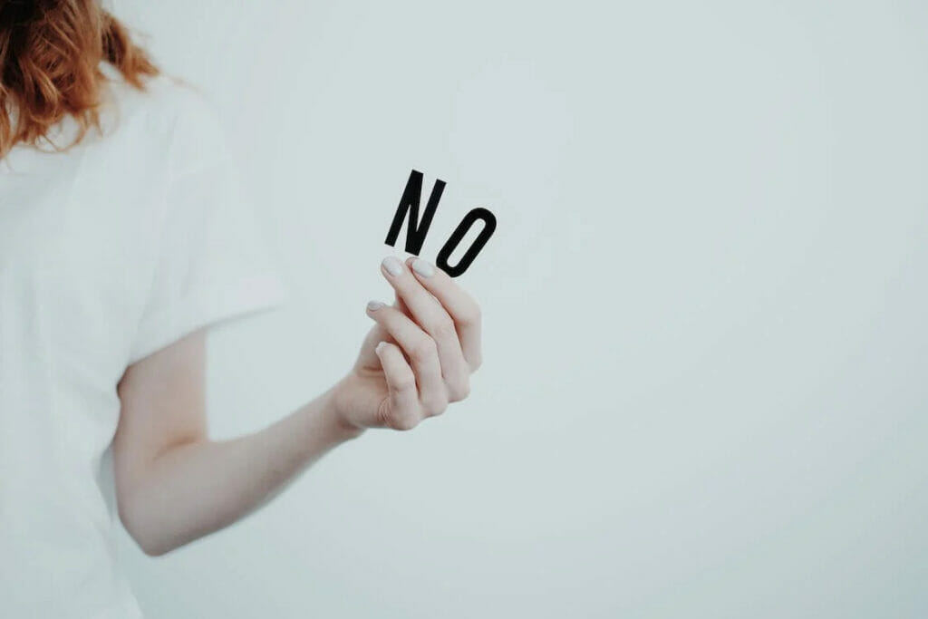 A woman holding a no sign