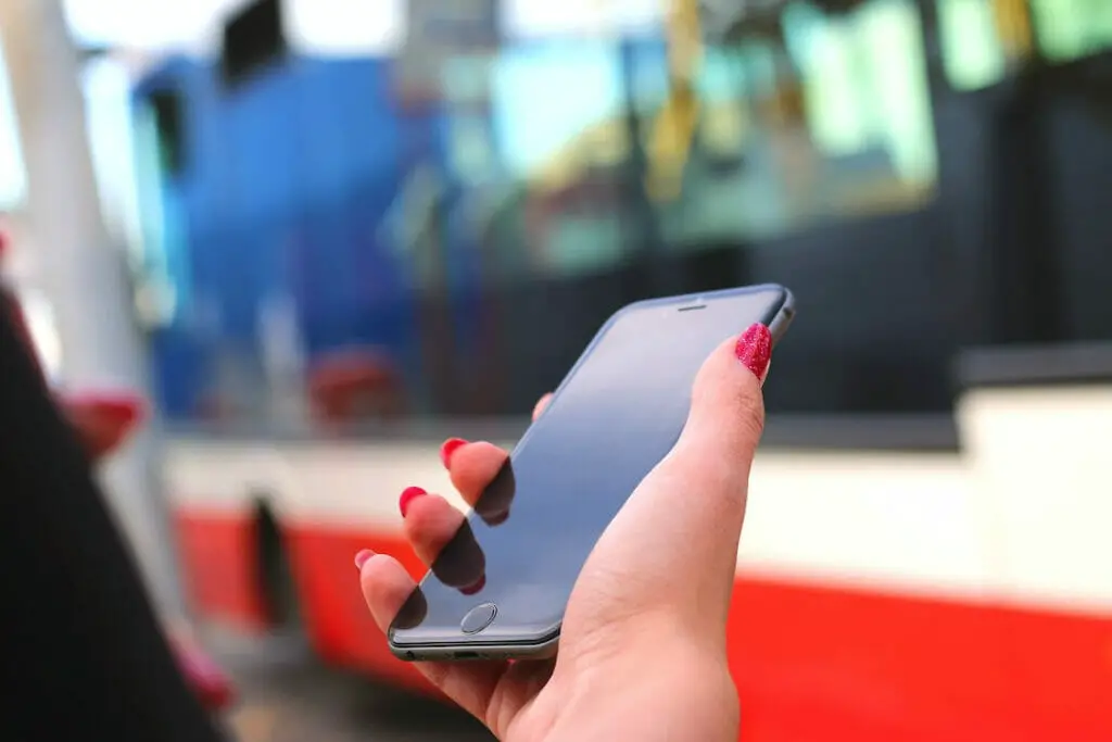 A woman with red nails holding a phone