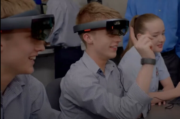 A group of students wearing virtual reality glasses in a classroom