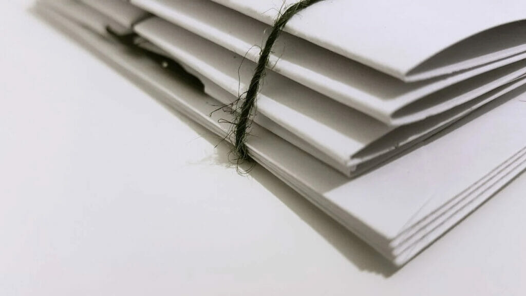 An piled white folder with lace in a white table
