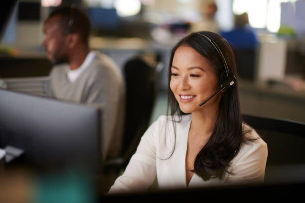 A woman wearing a headset in a call center